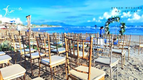 a bunch of chairs sitting on the beach at Funtasea Hotel and Beach Resort in Iba