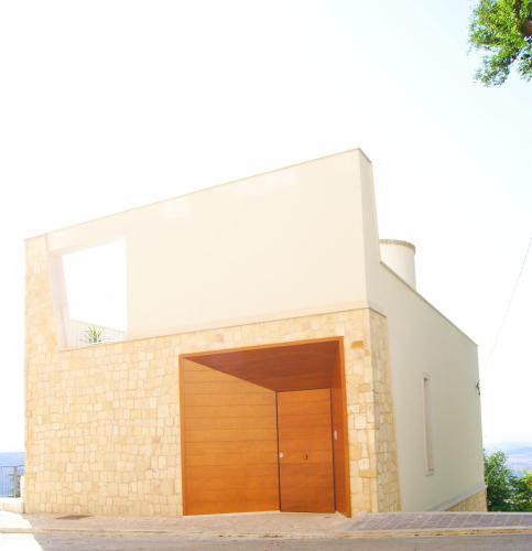 a brick building with a wooden garage door at Bora B&B in Troia