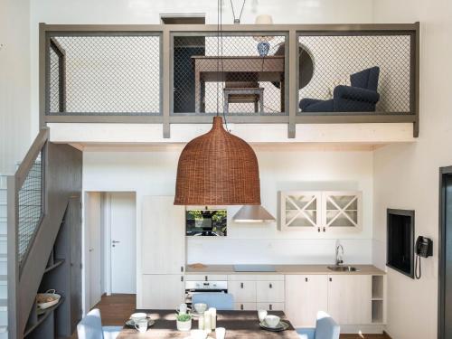 a kitchen and dining room with a loft conversion at Forest Mansion Retreat in Antoing