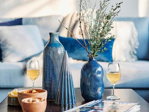 a table with two vases and two glasses of wine at Elegant Mansion with Pools in Antoing