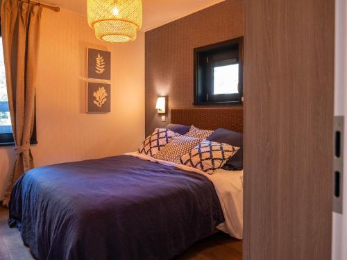 a bedroom with a bed and a window at Elegant Mansion with Pools in Antoing