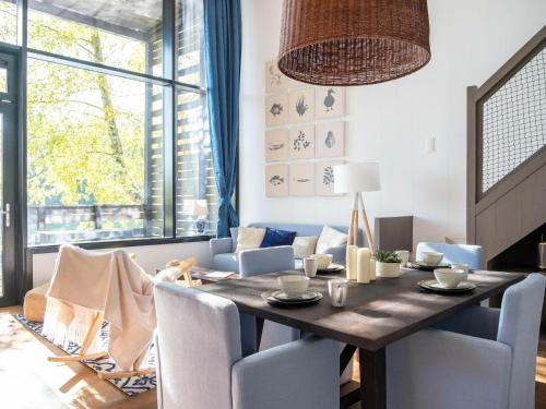 a dining room with a wooden table and chairs at Forest Mansion Retreat in Antoing