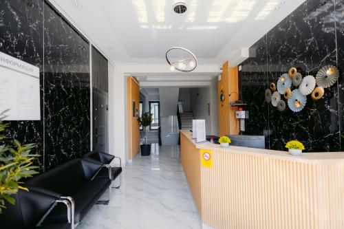 an office lobby with a reception counter and chairs at SADI Hotel in Yakkasaray