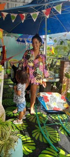 a woman and a child standing under an umbrella at MANOA "Lugar de descanso" HABITACION CON VISTA A LA CIUDAD, FRESCO Y VENTILADO in Ibagué