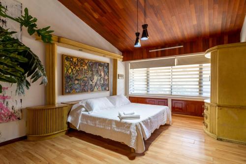 a bedroom with a bed and a window at Casanova Suites & Hostel in Guadalajara