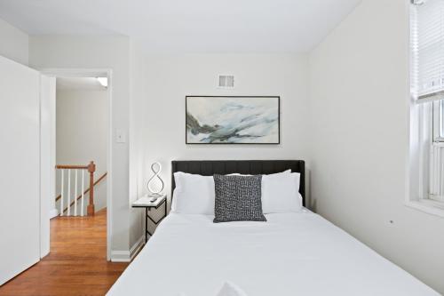a white bedroom with a bed and a desk at -- 2 King Beds & Free Parking -- Vintage Retreat -- Floyd's Freedom in Alexandria