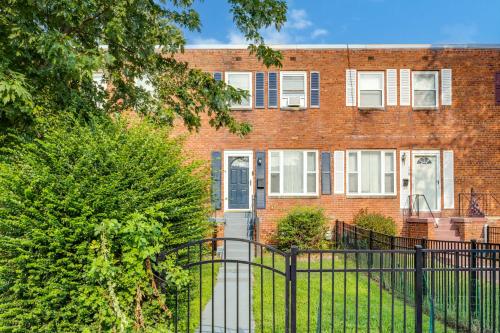 a brick building with a black fence in front of it at --Free Parking & 2 King Beds -- Vintage Retreat -- Floyd's Freedom in Alexandria