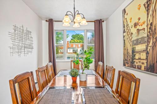 a dining room with a table and chairs and a window at --Free Parking & 2 King Beds -- Vintage Retreat -- Floyd's Freedom in Alexandria
