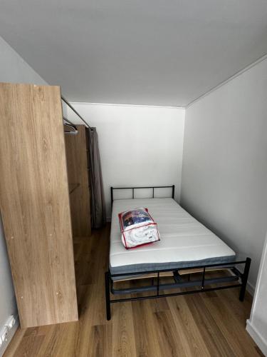 - une petite chambre avec un lit et du parquet dans l'établissement Appartement 30m2 centre ville, à Saint-Cyr-sur-Loire