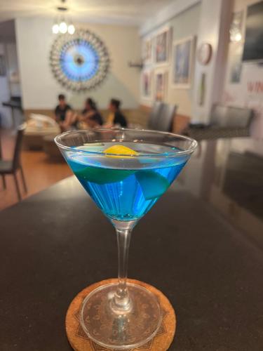 a blue drink in a glass sitting on a table at Funtasea Hotel and Beach Resort in Iba