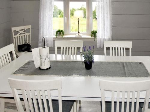 a dining room with a white table and chairs at 9 person holiday home in Åram in Sandvik