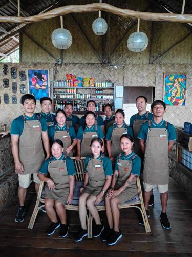 a group of people posing for a picture in a store at Prince John Beachfront Eco Bungalows and Restaurant in San Vicente