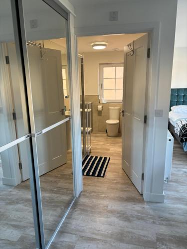 a room with a bathroom with a bed and a mirror at large en suite bedroom with one double bed No breakfast provided in Edinburgh
