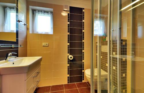 a bathroom with a toilet and a glass shower at Hotel Jirinka in Dolní Morava