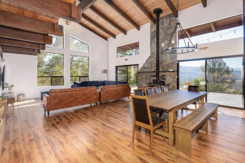 a dining room with a table and a couch at Yosemite Sunrise House with hot tub/views/game room! in Yosemite Forks