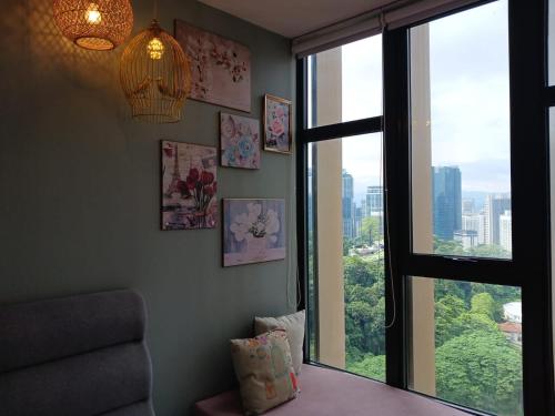 a room with a window with a view of a city at Ceylonz Suites By ANA MALAYSIA in Kuala Lumpur