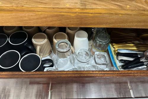a wooden drawer filled with different types of utensils at Tubod Mar Terraza 3 bedrooms and basement up to 18 pax in Larapan