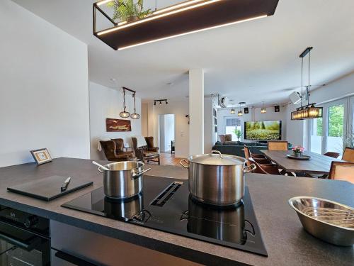 a kitchen with two large pots on a stove top at BETTER l industriaI apartment l Heimkino in Altusried