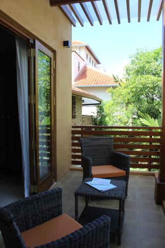 a patio with chairs and a table and a table at Urban Bliss Studio in Colombo