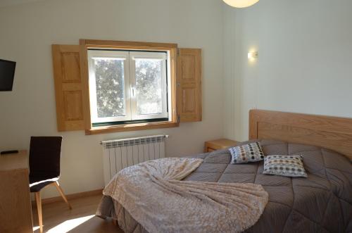 Ένα ή περισσότερα κρεβάτια σε δωμάτιο στο Casas do Mondego