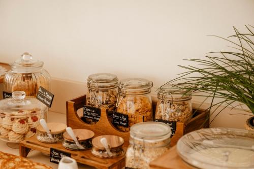 a table with jars of food and a plant at BAYIT Charming Place in Polignano a Mare