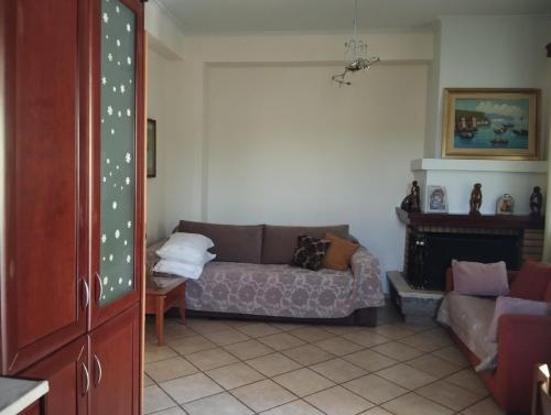 a living room with a couch and a fireplace at Studio eva in Palouki