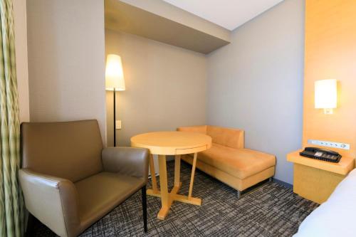 a small room with a table and a chair at Richmond Hotel Premier Sendai Ekimae in Sendai
