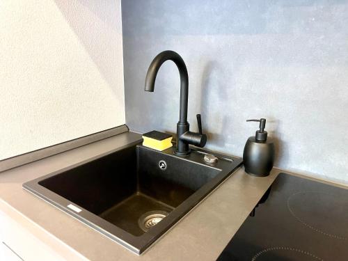 a kitchen counter with a sink with a faucet at NEU Schwarzwald Zimmer am Schlössle Goldstadt Pforzheim in Pforzheim
