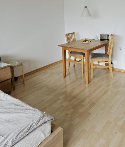 a bedroom with a table and chairs and a bed at Apartment 707 mit Pool in Lahnstein