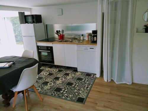 une cuisine avec une table et un comptoir dans l'établissement Charmant loft avec jardin près du centre ville, à Amboise