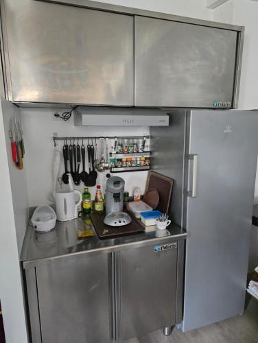 a small kitchen with a stainless steel refrigerator at Private Living Central, Dampfdusche in Köflach