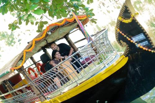 a group of people riding on a roller coaster at Riverbliss - River Retreat with Private Pool in Talavadi