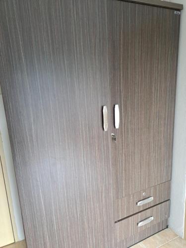 a metal door with two windows in a room at Relax home massage Ao nang 1 in Ao Nang 