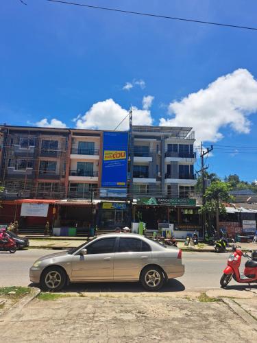 a car parked in a parking lot in front of a building at Relax home massage Ao nang 1 in Ao Nang 