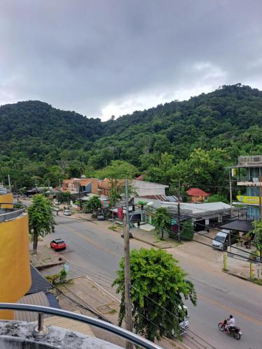 a city street with a mountain in the background at Relax home massage Ao nang 1 in Ao Nang 