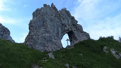a large rock formation on a grassy hill at PRIMA DEL CIELO - appartamento LAGO in Esino Lario
