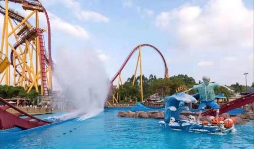 a water park with a roller coaster in the water at Guangzhou He She Art Apartment in Guangzhou