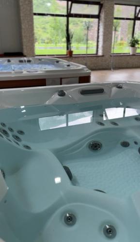 a bathroom with three sinks in a room at Mountain View Hot Spring Resort in Alamedin