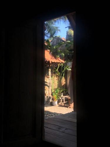 an open door to a yard with a house at Omah Guyub in Ngabean