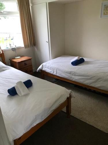 a hotel room with two beds and a window at Ty Haf in Swansea