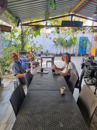 a man and a woman sitting at a table at Dream Vision Guest House in Diu