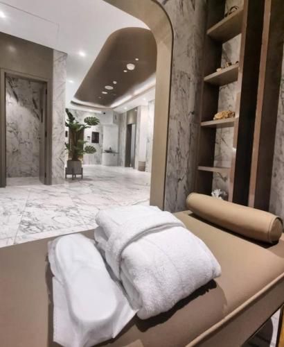 a bathroom with white towels sitting on a counter at Bright High Floor Apartment in a 5 Star Hotel Resident Tower w Burj View and access to 64th Infinity Pool, Gym, Sauna, Spa, Restaurants, Bars and more in Dubai