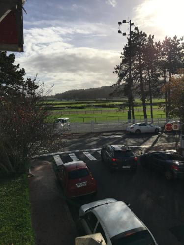 a group of cars parked in a parking lot at MAISON DE VILLE Deauville in Deauville