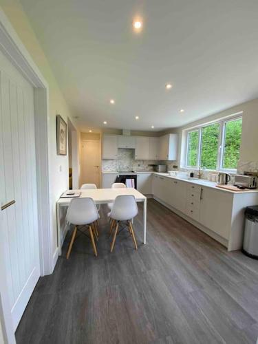 a large kitchen with a table and chairs in it at Larks Leaze Lodge, Steeple Ashton, Wiltshire in Trowbridge