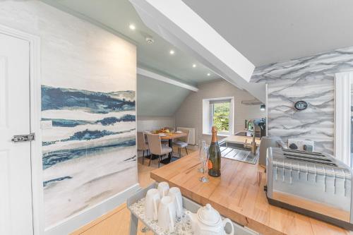 a kitchen and dining room with a painting on the wall at Fell215 - Classic loft apartment at The Lairbeck in Keswick in Keswick