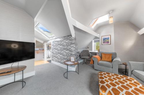 a living room with a large flat screen tv at Fell215 - Classic loft apartment at The Lairbeck in Keswick in Keswick