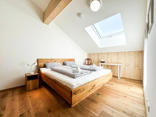 a bedroom with a bed with a skylight at Staufner Maisonette in Oberstaufen