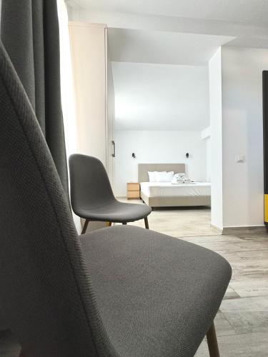 a chair in a room with a bed in the background at Vila Eric in Eforie Sud
