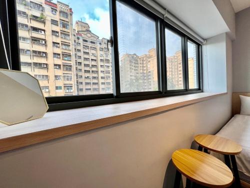 a room with two stools and a window with a view at 澄居 live in in Taichung