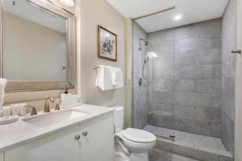 a bathroom with a toilet and a sink and a shower at Charming California Condos - Near it All in New Orleans